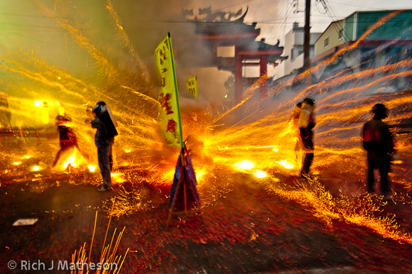 A barrage of firecrackers and bottle rockets blast gods in palanquins and their bearers at the annual Yenshui beehive fireworks festival in Yanshui Village, Tainan County, Taiwan