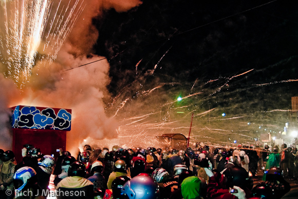 Revelers wearing motorcycle helmets at Yanshui Fireworks Festival